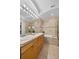 Bathroom featuring double sinks, tiled surround bathtub, and glass-enclosed shower at 45 N Ogden St # 201, Denver, CO 80218