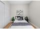 Bedroom featuring a queen-sized bed with side table and abstract art at 45 N Ogden St # 201, Denver, CO 80218