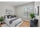 Bedroom featuring a queen-sized bed and bench with decorative pillows at 45 N Ogden St # 201, Denver, CO 80218