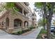 Beautiful condo exterior with multiple balconies, decorative columns, and manicured landscaping at 45 N Ogden St # 201, Denver, CO 80218