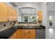 Bright kitchen features a passthrough to the living area, modern appliances, and dark countertops at 45 N Ogden St # 201, Denver, CO 80218