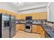 Functional kitchen offers stainless steel appliances, light wood cabinets, and sleek black countertops at 45 N Ogden St # 201, Denver, CO 80218