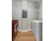 Bright laundry room with red front-load washer, white dryer, and wood-look flooring at 45 N Ogden St # 201, Denver, CO 80218