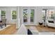 Bright living room with access to a balcony, light wood floors, and neutral tones at 45 N Ogden St # 201, Denver, CO 80218