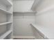 Walk-in closet featuring white shelving and laminate flooring at 45 N Ogden St # 201, Denver, CO 80218