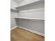 Walk-in closet featuring hardwood floors and white shelving at 45 N Ogden St # 201, Denver, CO 80218
