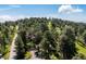 Aerial view of a home nestled among lush trees with a long private driveway at 24999 Grandview Ave, Golden, CO 80401