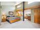 Rustic bedroom boasts a wooden bed frame, wood beam accents, and lots of natural light at 24999 Grandview Ave, Golden, CO 80401