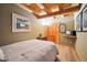 Comfortable bedroom with wood ceiling and floors, featuring a cozy bed and closet at 24999 Grandview Ave, Golden, CO 80401