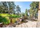 Spacious deck with outdoor seating, grill, and views of the surrounding greenery at 24999 Grandview Ave, Golden, CO 80401