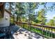 Home's wooden deck offers peaceful views of the surrounding forest at 24999 Grandview Ave, Golden, CO 80401