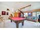Spacious game room featuring a pool table, sofa, and carpeted floors at 24999 Grandview Ave, Golden, CO 80401