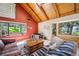 Cozy living room featuring wood-beamed ceilings, large windows, and comfortable seating area with rustic decor at 24999 Grandview Ave, Golden, CO 80401