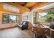 Bright living room with wood-beamed ceilings, hardwood floors, and picturesque views at 24999 Grandview Ave, Golden, CO 80401