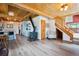 Open concept living space with wood-beamed ceilings, hardwood floors, and fireplace at 24999 Grandview Ave, Golden, CO 80401