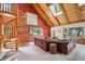 Inviting living room with wooden ceilings, brick-colored walls, and spiral staircase that adds charm at 24999 Grandview Ave, Golden, CO 80401