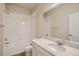 Well-lit bathroom featuring a shower and tub combination, a single sink, and a large mirror at 6847 Huddersfield Ln, Castle Pines, CO 80108