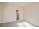 Neutral bedroom with neutral carpet, white trim and open door to vanity at 6847 Huddersfield Ln, Castle Pines, CO 80108