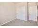 Bedroom features neutral paint, carpet, a closet with sliding doors, and a door at 6847 Huddersfield Ln, Castle Pines, CO 80108