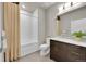 Bathroom featuring a tub and shower combination, tiled walls, and modern vanity at 6619 E Lowry Blvd # 112, Denver, CO 80230