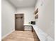 Bedroom with a murphy bed, desk space, and hardwood floors for a flexible living area at 6619 E Lowry Blvd # 112, Denver, CO 80230