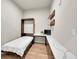 Bedroom with a murphy bed, desk space, and hardwood floors for a flexible living area at 6619 E Lowry Blvd # 112, Denver, CO 80230