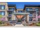 Beautiful condominium entrance featuring brick facade, modern architectural design and well maintained landscape at 6619 E Lowry Blvd # 112, Denver, CO 80230