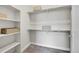 Walk-in closet with shelving and hanging space, offering ample storage solutions at 6619 E Lowry Blvd # 112, Denver, CO 80230