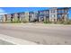 Lovely condo building with many balconies, nice brick facade, and attractive landscaping along a wide road at 6619 E Lowry Blvd # 112, Denver, CO 80230