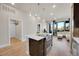 Modern kitchen with island, stainless steel appliances, and modern lighting open to living area at 6619 E Lowry Blvd # 112, Denver, CO 80230
