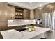 Close up of kitchen island with stainless steel appliances, modern cabinets, and white counter tops at 6619 E Lowry Blvd # 112, Denver, CO 80230