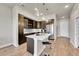 Gourmet kitchen featuring stainless steel appliances, a modern island, and stylish pendant lighting at 6619 E Lowry Blvd # 112, Denver, CO 80230