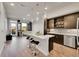 Open floor plan featuring kitchen with island, stainless steel appliances, and modern lighting at 6619 E Lowry Blvd # 112, Denver, CO 80230
