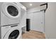 A laundry room with stacked washer and dryer unit and closet storage for convenience at 6619 E Lowry Blvd # 112, Denver, CO 80230