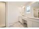 Modern bathroom with double vanity, marble floors, and glass-enclosed shower at 2956 S Quaker St, Morrison, CO 80465