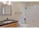 A bathroom with a modern vanity and a tiled shower and bathtub at 1530 S Quebec Way # 34, Denver, CO 80231