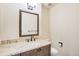 Well-lit bathroom featuring a granite countertop vanity, a decorative mirror, and a tiled floor at 1530 S Quebec Way # 34, Denver, CO 80231