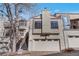Charming townhome featuring a two-car garage and stucco siding, complete with a cozy front porch entrance at 1530 S Quebec Way # 34, Denver, CO 80231