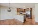An open kitchen features stainless steel appliances, dark wood cabinets, and a breakfast bar at 1530 S Quebec Way # 34, Denver, CO 80231