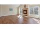 Bright living room with hardwood floors and a fireplace, creating a warm and inviting atmosphere at 1530 S Quebec Way # 34, Denver, CO 80231