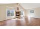 Inviting living room featuring a cozy fireplace, large windows, and hardwood floors throughout the space at 1530 S Quebec Way # 34, Denver, CO 80231