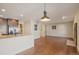 The living room opens to the kitchen, with hardwood floors and contemporary lighting at 1530 S Quebec Way # 34, Denver, CO 80231