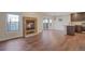 Open layout integrating the living area, dining space, and kitchen, all adorned with hardwood floors at 1530 S Quebec Way # 34, Denver, CO 80231