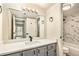 Updated bathroom with gray vanity and marble shower/tub at 3549 S Fairplay Way # 10, Aurora, CO 80014