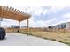 Concrete patio with a wood pergola overlooks a spacious backyard, offering a private outdoor space at 5937 N Orleans St, Aurora, CO 80019