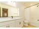 Bathroom featuring a bright mirror, white cabinets, and tile surrounding the bathtub and shower at 5937 N Orleans St, Aurora, CO 80019