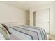 Bedroom featuring carpet, a closet, and blue and gray comforter at 5937 N Orleans St, Aurora, CO 80019