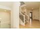 Bright foyer with light wood floors and a staircase with black wrought iron railing at 5937 N Orleans St, Aurora, CO 80019