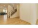 Bright foyer with light wood floors and a staircase with black wrought iron railing at 5937 N Orleans St, Aurora, CO 80019