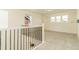 Upstairs hallway with gray carpet, iron railing, and bright windows looking to the outside at 5937 N Orleans St, Aurora, CO 80019